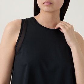 Model wearing Spanx Sheeriours Panel Performance Top in Very Black, featuring sleeveless silhouette with sheer mesh panel detail at shoulder