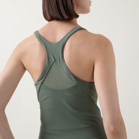 Model wearing Spanx BoostUp Shelf Tank in Eucalyptus, showing racer-style back with mesh panel detail for breathability.