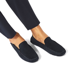 Model wearing KG by Kurt Geiger blue suede slip-on loafers with moccasin stitching detail, styled with navy trousers