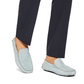 Model wearing KG by Kurt Geiger blue suede loafers with moccasin stitching and rubber sole, styled with navy tailored trousers.