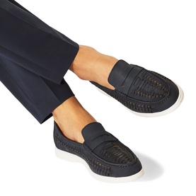 Model wearing KG by Kurt Geiger blue woven slip-on loafers with white flatform sole, styled with navy tailored trousers