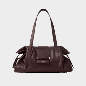 Deep burgundy leather shoulder bag with bow detail sides, gold-tone hardware, and dual top handles