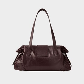 Deep burgundy leather shoulder bag with ruched side panels, single top handle, and front press-stud flap detail