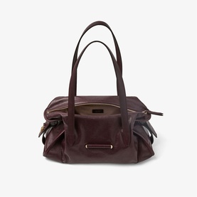 Burgundy leather shoulder bag with dual top handles, side zip pockets, and silver-tone hardware detail at front