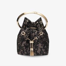 Black lace bucket bag with gold-tone rigid top handle, drawstring closure, and tassel detail on nude lining base