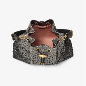 Black crystal-embellished bucket bag with gold hardware, open-top view revealing pink suede interior lining and adjustable strap