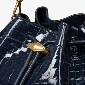 Jimmy Choo blue croc-embossed patent leather bucket bag with gold-tone lock hardware and drawstring detail