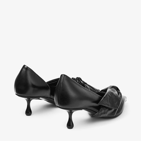 Jimmy Choo black leather kitten heel pumps with ruched bow detail, shown from rear three-quarter angle on white background.