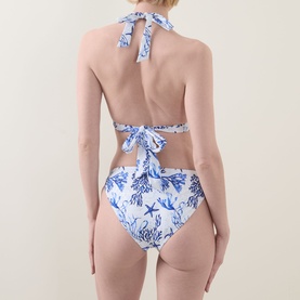 Model wearing Naia Beach Elba La Mer Print Bikini Briefs in blue and white coral print, low-rise with wide side panels; styled with matching