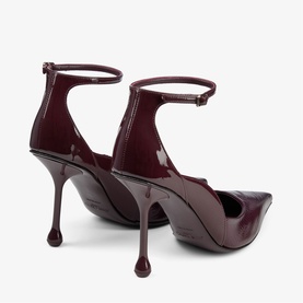 Jimmy Choo deep merlot patent leather stiletto heels with ankle strap and sculptural ball-tip heel, rear view