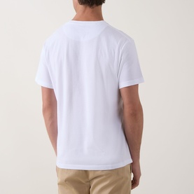 Model wearing white crew-neck short-sleeve T-shirt, back view, styled with beige chino trousers