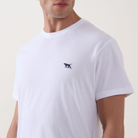 Model wearing white crew neck T-shirt with small navy embroidered logo at chest