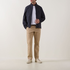 Model wearing navy zip-up harrington jacket, styled with white tee, beige chinos and cream trainers