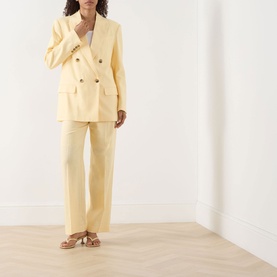 Model wearing Selected Femme Italian Straw blazer in viscose-linen blend, styled with matching wide-leg trousers and tan heeled sandals.