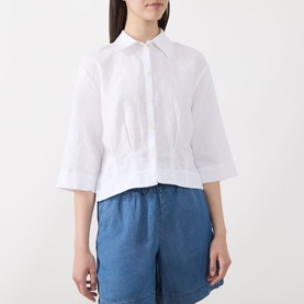 Model wearing Selected Femme Bright White linen-cotton cropped shirt with pintuck detail, styled with blue wide-leg trousers.