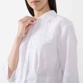 Model wearing Selected Femme bright white linen-cotton shirt, close-up detail of collar and button placket