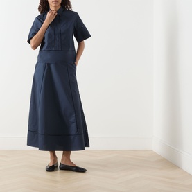 Model wearing Selected Femme Dark Sapphire cotton midi skirt with patch pockets, styled with matching crop shirt and black ballet flats.