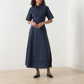 Model wearing Selected Femme Dark Sapphire cotton midi skirt with matching shirt top, styled with black flat loafers.