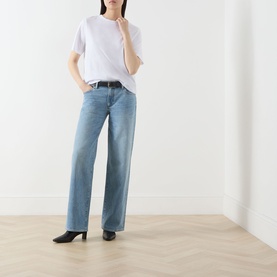 Model wearing Selected Femme Assia Solid T-Shirt in Bright White with light-wash wide-leg jeans and black heeled mules.