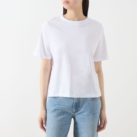 Model wearing Selected Femme Assia Solid T-Shirt in Bright White with round neck and short sleeves, styled with light blue jeans.