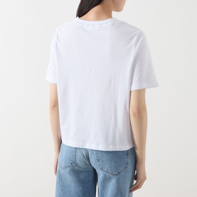 Model wearing Selected Femme Assia Solid T-Shirt in Bright White, back view, with light blue jeans. Round neck, short sleeves, straight hem.