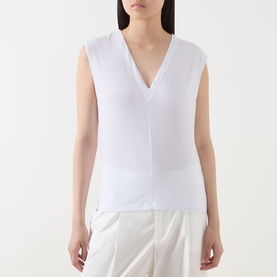 Model wearing Selected Femme Berta Stitched Tank Top in Bright White, V-neckline, sleeveless with front seam detail, styled with white trousers.