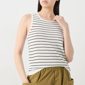 Model wearing Selected Femme Moon Striped Knitted Vest in Birch/Black Stripes, sleeveless with round neck, styled with khaki shorts