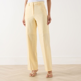 Model wearing Selected Femme Italian Straw wide-leg linen-blend trousers, styled with strappy flat sandals