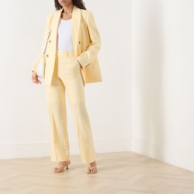Model wearing Selected Femme Italian Straw linen-viscose trousers with matching blazer and white top, styled with nude heeled sandals.
