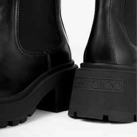 Jimmy Choo black leather Chelsea boots with chunky lug sole and block heel, logo embossed on sole edge