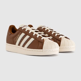 Adidas Superstar trainers in dusky bronze and cream white, leather upper with three stripe detail and shell toe, off-white sole