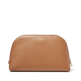 Aspinal of London caramel leather cosmetics case with dome shape, zip fastening, and gold-tone hardware detail.
