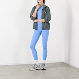 Model wearing Adanola Blossom Blue leggings, styled with an olive zip-up jacket, blue top and grey trainers with white socks.