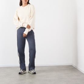 Model wearing Adanola Midnight Blue Sweat Bottoms with side stripe detail, styled with cream knit sweater and grey trainers