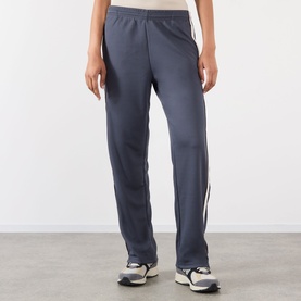 Model wearing Adanola Midnight Blue sweat bottoms with white side stripe, styled with white trainers.