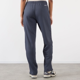 Model wearing Adanola Midnight Blue Sweat Bottoms, rear view, styled with white trainers, relaxed straight-leg fit with elasticated waist.