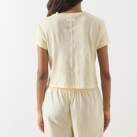 Model wearing Adanola ButterCream cotton T-shirt, back view, styled with matching wide-leg trousers