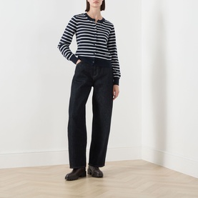 Model wearing Barbour Baiton Striped Cardigan in Dark Navy Stripe with wide-leg dark jeans and black loafers.