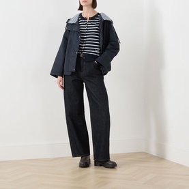 Model wearing Barbour Baiton Striped Cardigan in Dark Navy Stripe, styled with dark trousers, navy jacket and black loafers.