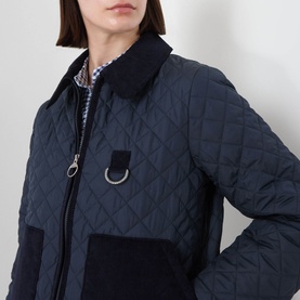 Model wearing Barbour Aylesby Quilted Jacket in Dark Navy, showing corduroy collar, D-ring detail and patch pocket. Styled with gingham shirt.