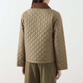 Model wearing Barbour Aylesby Quilted Jacket in Dusky Green, showing back view with corduroy collar and diamond quilted finish, styled with khaki