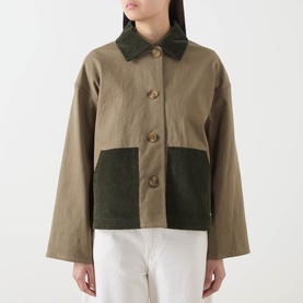 Model wearing Barbour Cloverdale Logo Jacket in Dusky Green with contrasting corduroy collar and patch pockets, styled with white trousers.