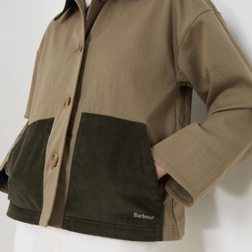 Model wearing Barbour Cloverdale Logo Jacket in Dusky Green, showing two-tone design with corduroy patch pockets and embroidered logo detail.