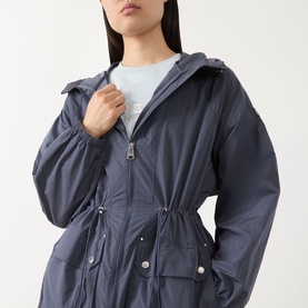 Model wearing Barbour International jacket in Odyssey, featuring hood, zip fastening, drawstring waist and snap button pockets, styled with light