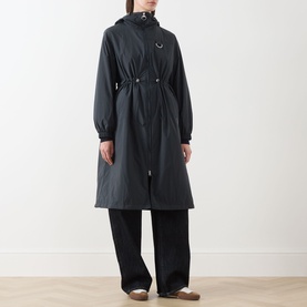 Model wearing Barbour Gracefield Showerproof Jacket in Dark Navy, long parka silhouette with hood, D-ring detail, styled with wide-leg black trousers.