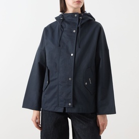 Model wearing Barbour Kingswood Showerproof Jacket in Dark Navy, hooded short-length style with snap button placket, styled with dark jeans.