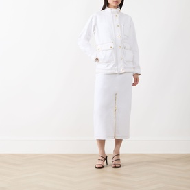 Model wearing Barbour International Kyla Biker Denim Jacket in Denim White with stand collar, gold buttons, and oversized flap pockets, styled with