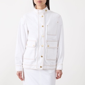 Model wearing Barbour International Kyla Biker Denim Jacket in Denim White with gold buttons, contrast stitching, oversized flap pockets and stand