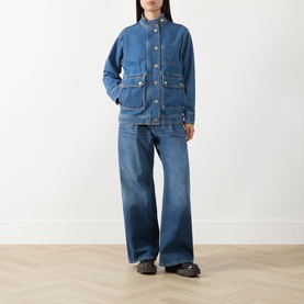 Model wearing Barbour International Nikki Biker Denim Jacket in Denim Blue with wide-leg jeans and dark loafers.