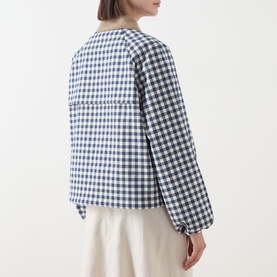Model wearing Barbour Ovingham Gingham Print Jacket in Navy/Neutral, rear view showing corduroy collar, blouson sleeves and gathered cuffs